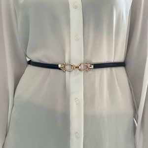 Black belt with gold clasp in front from Express. Tightens and loosens from side